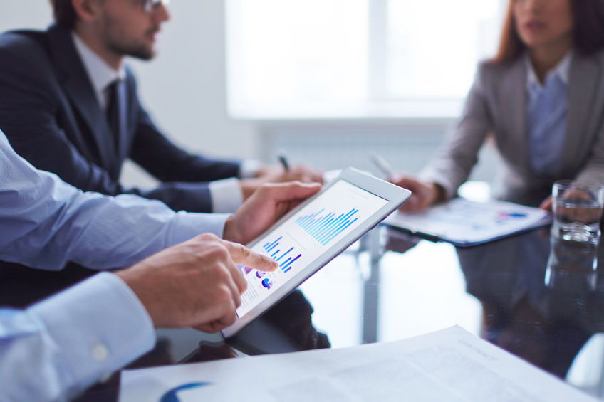 Xponentia team members discussing investment strategy in a business meeting